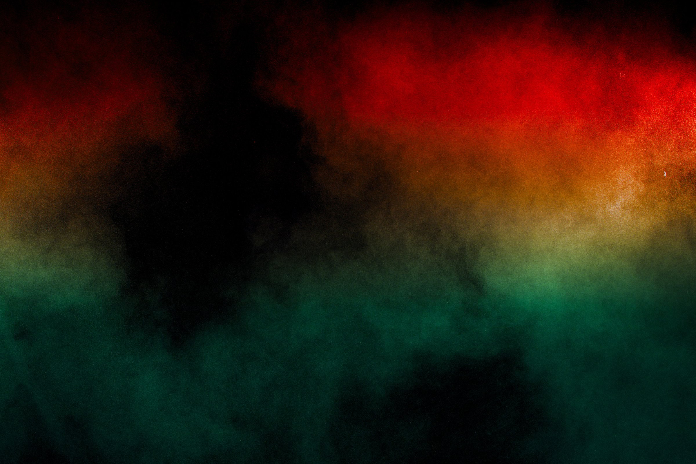 Red Green color powder explosion on black background.